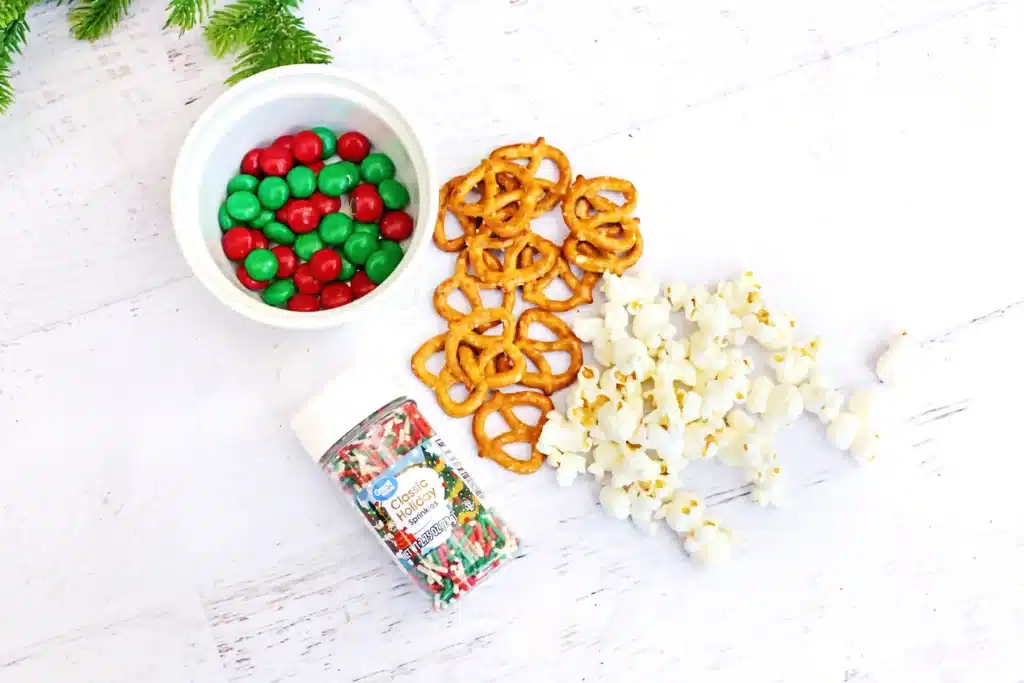Rudolph Popcorn Snack Mix - Cultivating Brilliant Minds sprinkles, rd and green m&ms, pretzels, and popcorn