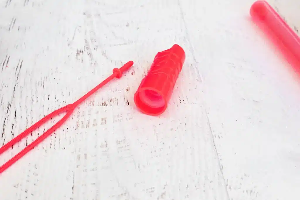 Candy Cane Sensory Wand - Cultivating Brilliant Minds removing the wand part from the bubble wand