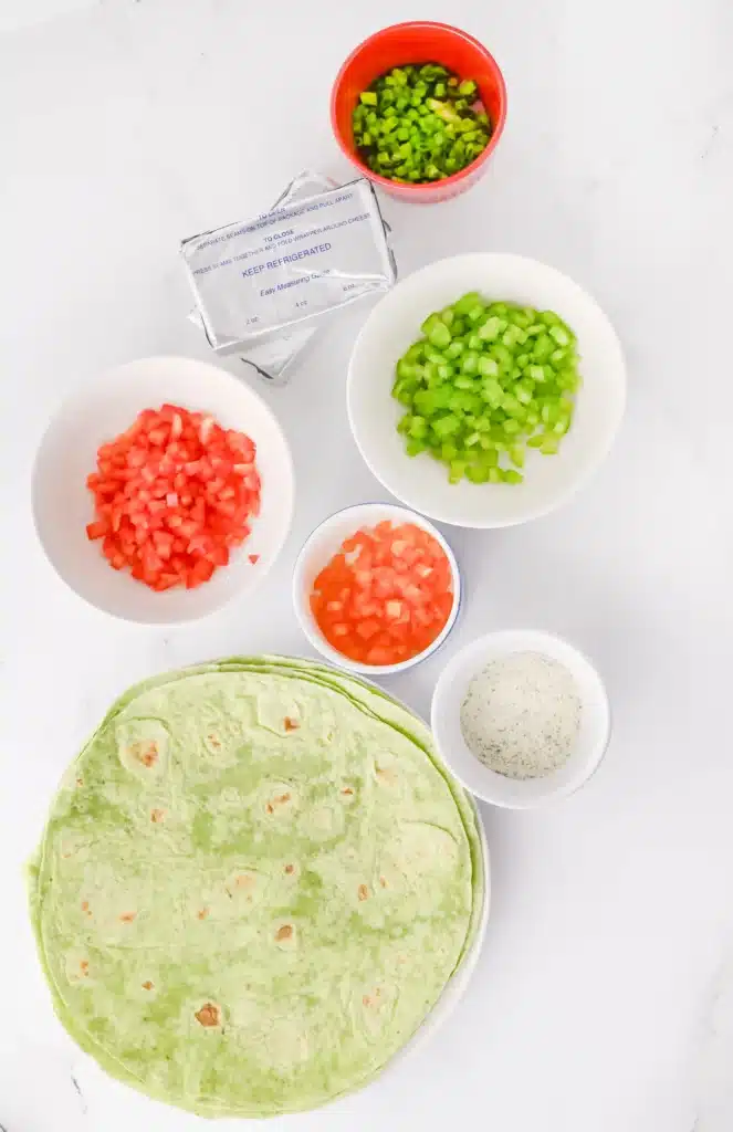Christmas Pinwheels - Cultivating Brilliant Minds spinach tortillas, green onion, orange bell pepper, celery, red bell pepper, ranch seasoning, and cream cheese