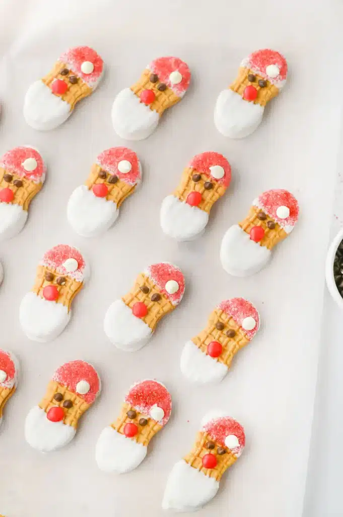 Santa Nutter Butters - Cultivating Brilliant Minds nutter butters decorated to look like Santa