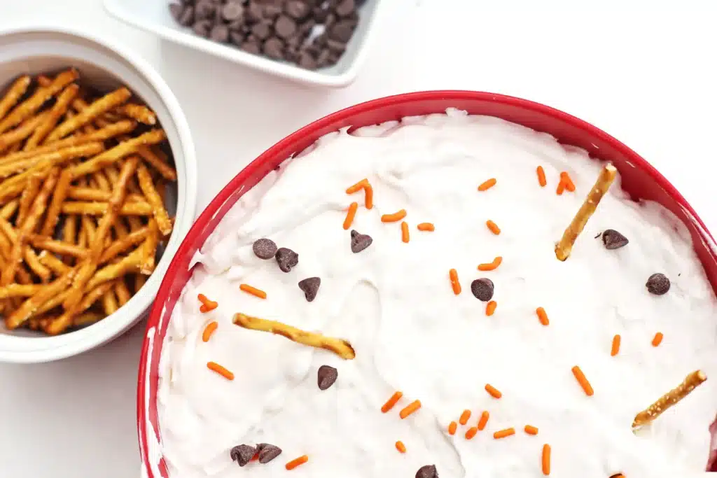 Melted Snowman Cheesecake Dip - Cultivating Brilliant Minds melted snowman cheesecake dip with mini pretzel sticks, crackers, and chocolate chips