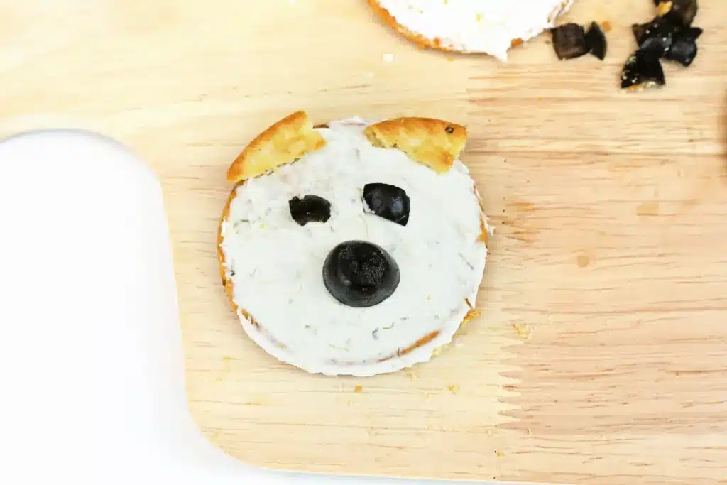 Savory Polar Bear Snacks - Cultivating Brilliant Minds crackers with cream cheese and olives to look like a polar bear