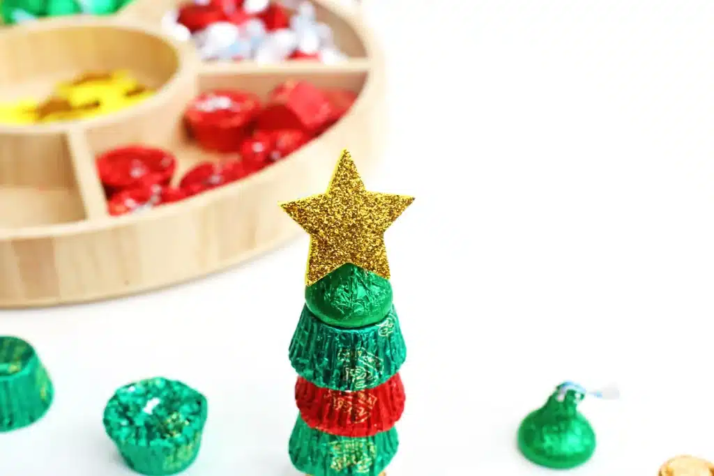 Candy Christmas Tree - Cultivating Brilliant Minds candies stacked on top of each other with a star sticker on top to look like a christmas tree
