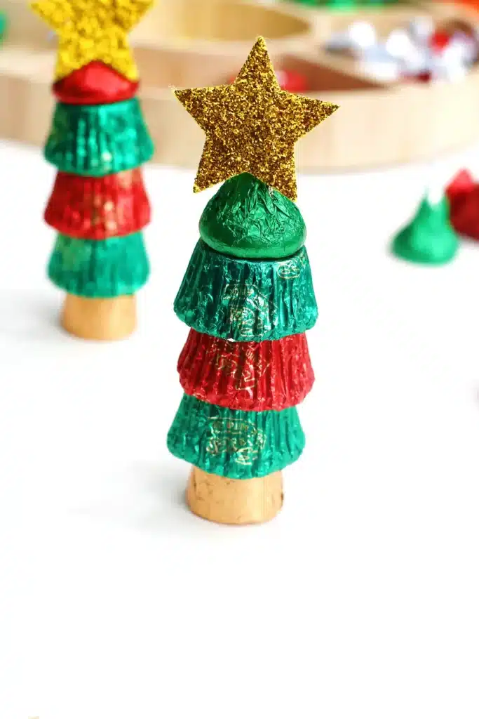 Candy Christmas Tree - Cultivating Brilliant Minds candies stacked on top of each other with a star sticker on top to look like a christmas tree