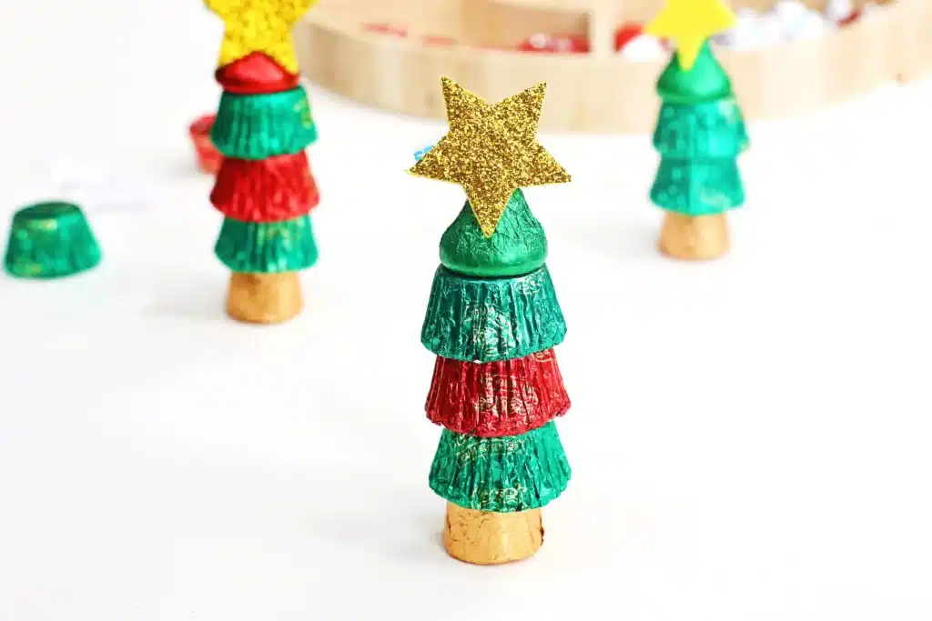 Candy Christmas Tree - Cultivating Brilliant Minds candies stacked on top of each other with a star sticker on top to look like a christmas tree