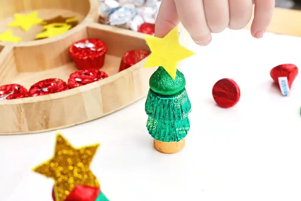 Candy Christmas Tree - Cultivating Brilliant Minds candies stacked on top of each other with a star sticker on top to look like a christmas tree