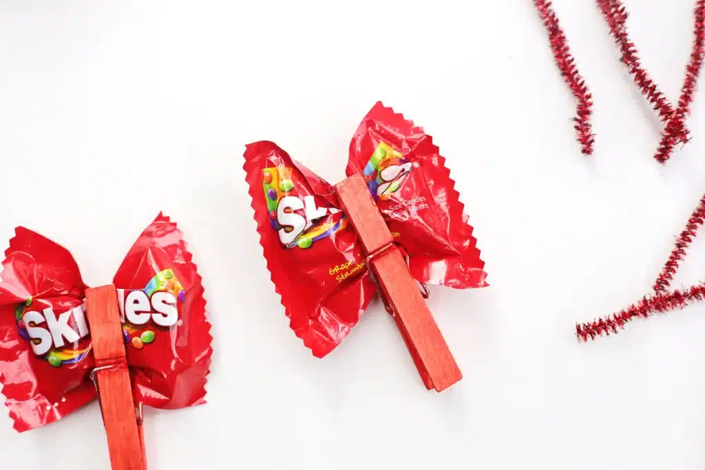 Valentine Candy Love Bugs - Cultivating Brilliant Minds a clothespin attached to a bag of skittles