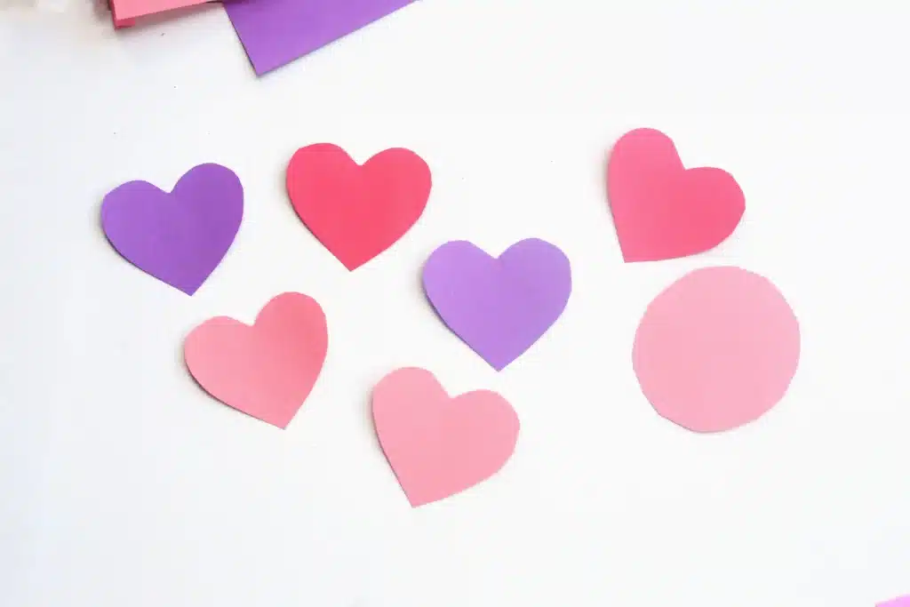 Heart Caterpillar Craft - Cultivating Brilliant Minds hearts cut out of red, pink, and purple construction paper