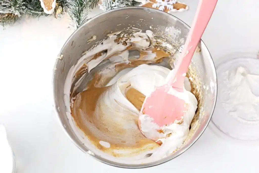 Gingerbread Dip - Cultivating Brilliant Minds folding in whipped cream to the molasses, brown sugar, powdered sugar, and cream cheese mixture