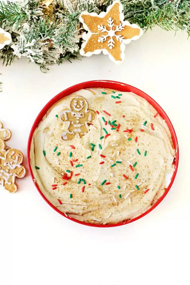 gingerbread dip with gingerbread cookies and christmas sprinkles in a bowl