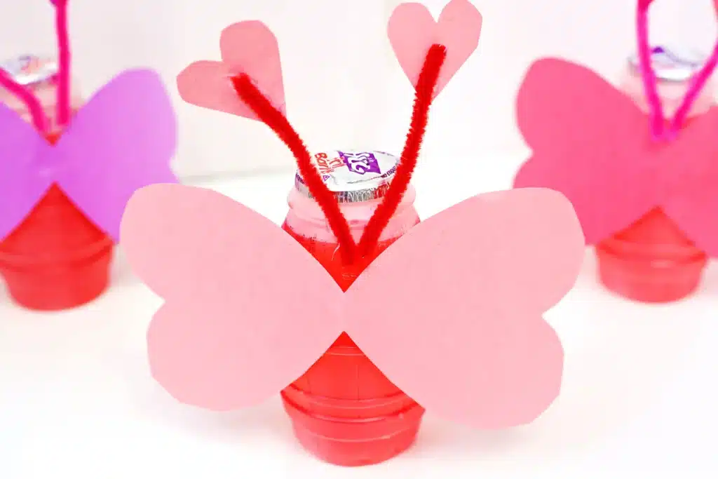 Love Bug Juices - Cultivating Brilliant Minds heart wings and pipe cleaner antennae glued to the hug drink