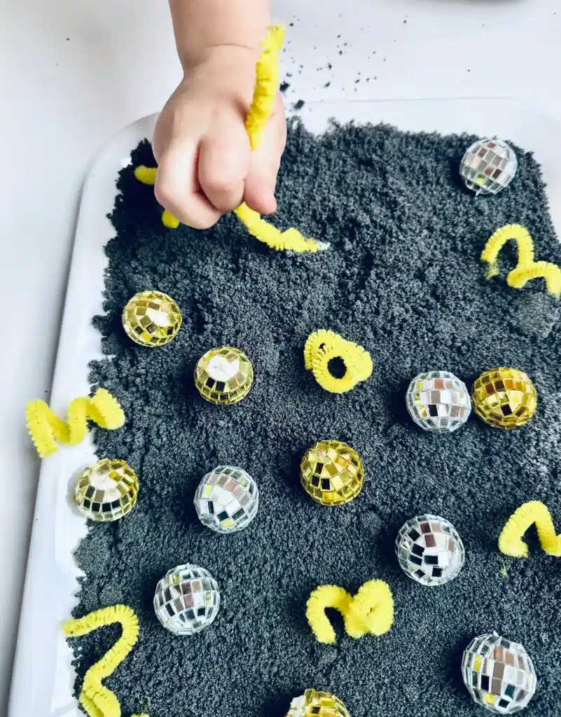 New Year's Eve Sensory Bin - Cultivating Brilliant Minds a new year's eve sensory bin with disco balls and yellow pipe cleaners