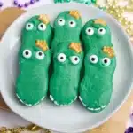 Mardi Gras Nutter Butter Alligators - Cultivating Brilliant Minds a nutter butter cookie coated in melted green chocolate decorated to look like an alligator