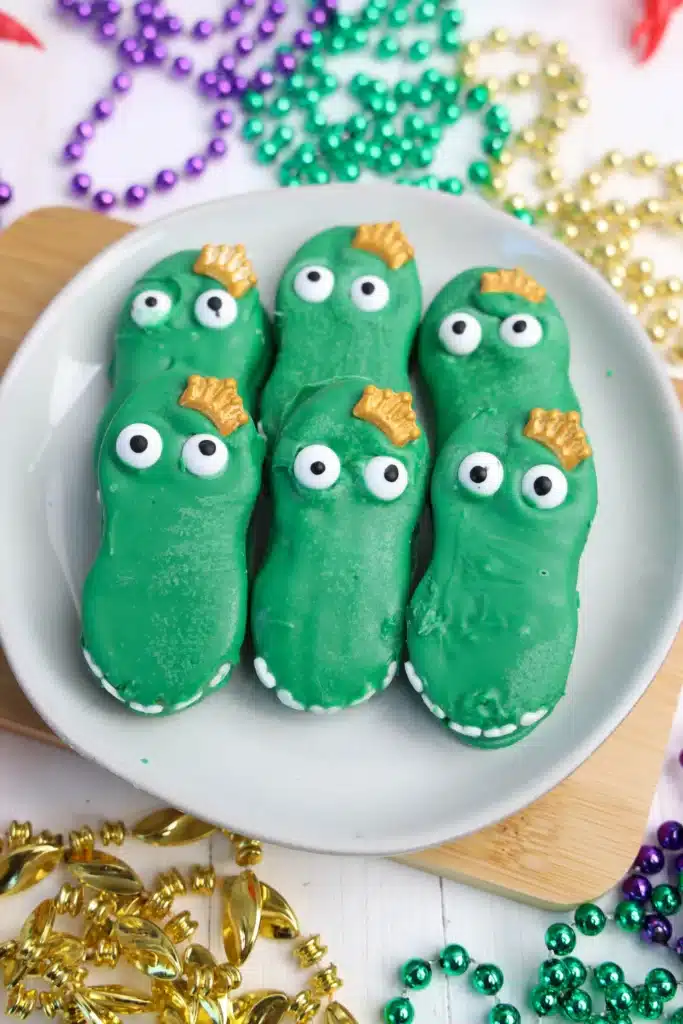 Mardi Gras Nutter Butter Alligators - Cultivating Brilliant Minds a nutter butter cookie coated in melted green chocolate decorated to look like an alligator