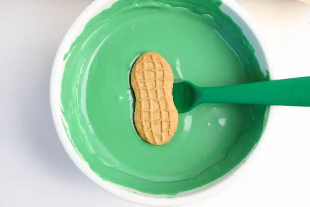 Mardi Gras Nutter Butter Alligators-10 - Cultivating Brilliant Minds a nutter butter cookie dipped in melted green chocolate