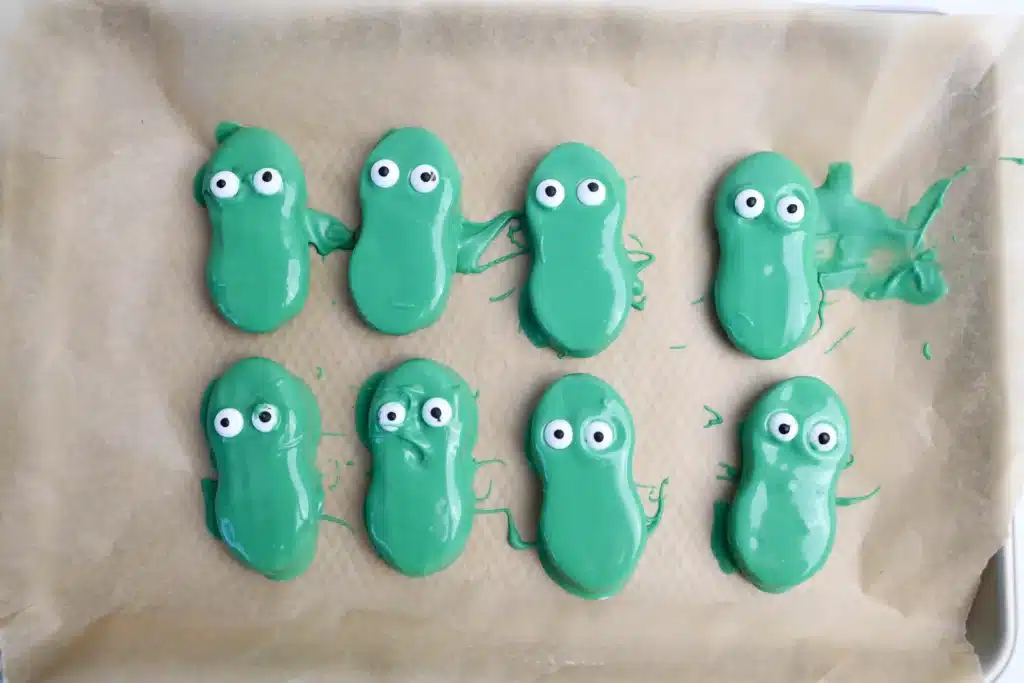 Mardi Gras Nutter Butter Alligators - Cultivating Brilliant Minds nutter butters covered in melted green chocolate and candy eyes