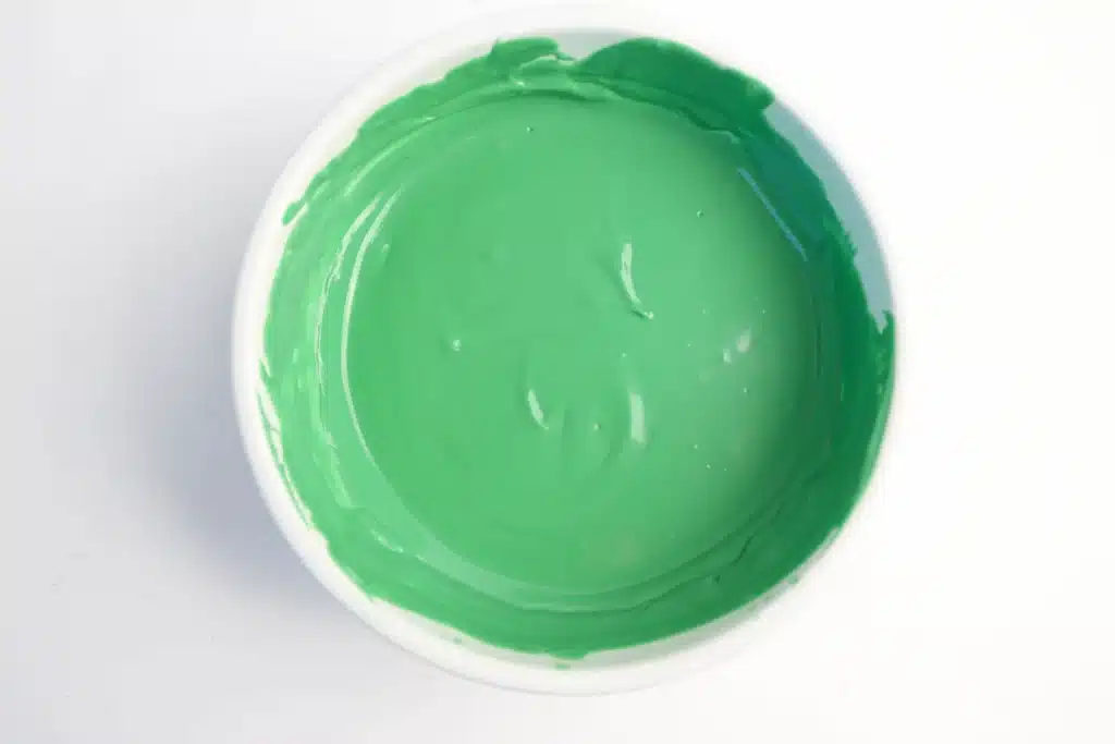 Mardi Gras Nutter Butter Alligators - Cultivating Brilliant Minds melted green candy melts in a bowl