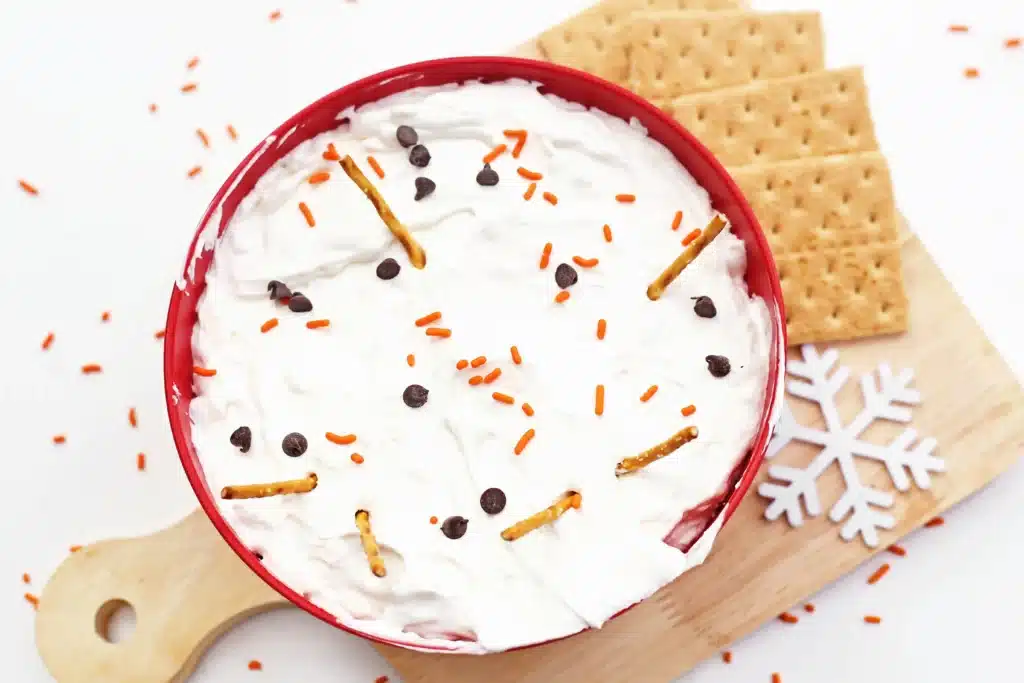 Melted Snowman Cheesecake Dip - Cultivating Brilliant Minds melted snowman cheesecake dip with mini pretzel sticks, crackers, and chocolate chips