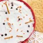 Melted Snowman Cheesecake Dip - Cultivating Brilliant Minds melted snowman cheesecake dip with mini pretzel sticks, crackers, and chocolate chips