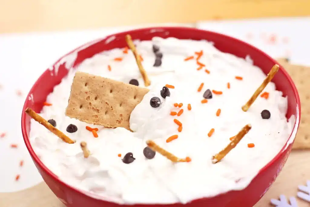 Melted Snowman Cheesecake Dip - Cultivating Brilliant Minds melted snowman cheesecake dip with mini pretzel sticks, crackers, and chocolate chips