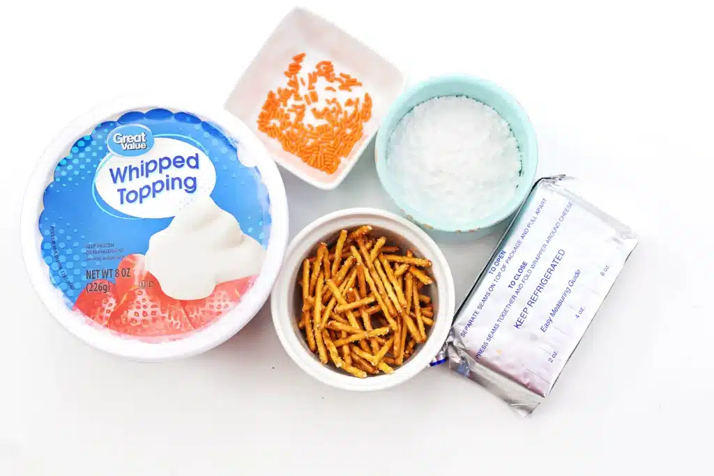 Melted Snowman Cheesecake Dip - Cultivating Brilliant Minds whipped topping, pretzel sticks powdered sugar, cream cheese, and orange sprinkles