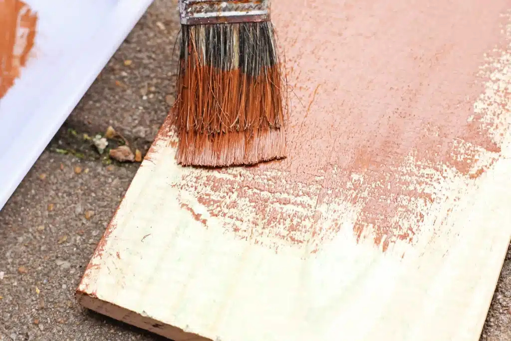 Wooden Gingerbread Keepsake Craft - Cultivating Brilliant Minds painting a wooden board brown