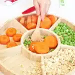 Reindeer Bait Sensory Bin - Cultivating Brilliant Minds a reindeer sensory bin filled with rolled oats, sliced carrots, and peas