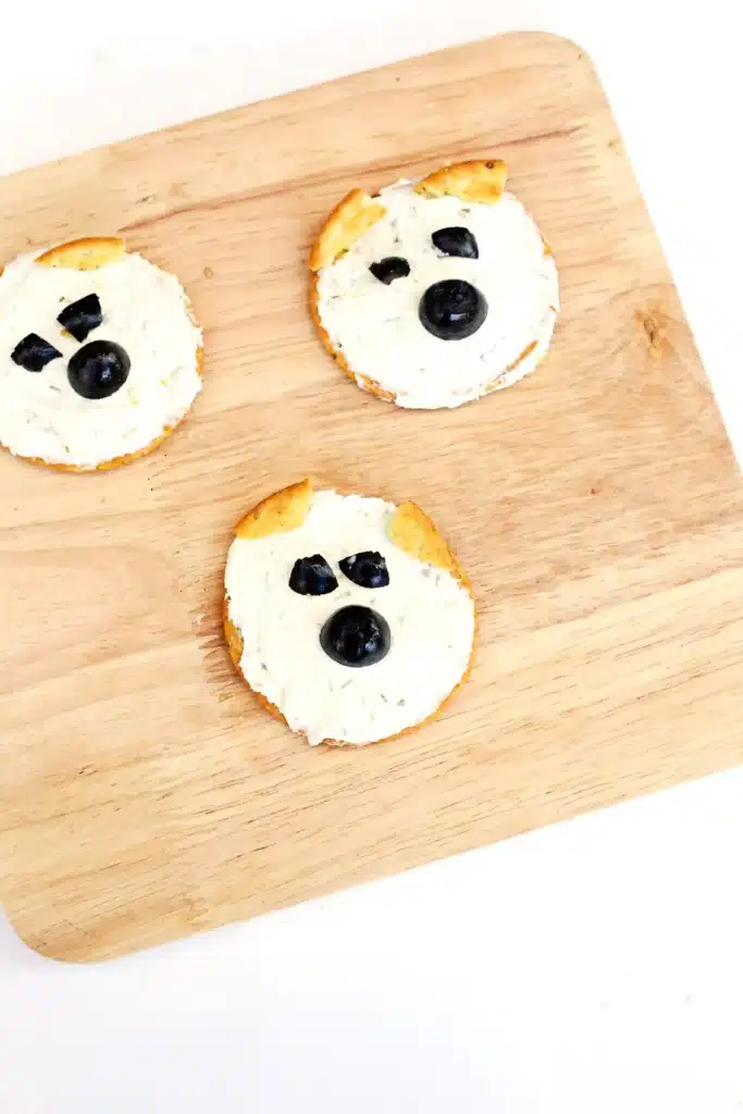 Savory Polar Bear Snacks - Cultivating Brilliant Minds crackers with cream cheese and olives to look like a polar bear