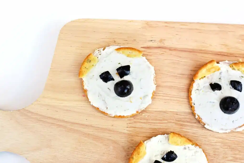 Savory Polar Bear Snacks - Cultivating Brilliant Minds crackers with cream cheese and olives to look like a polar bear