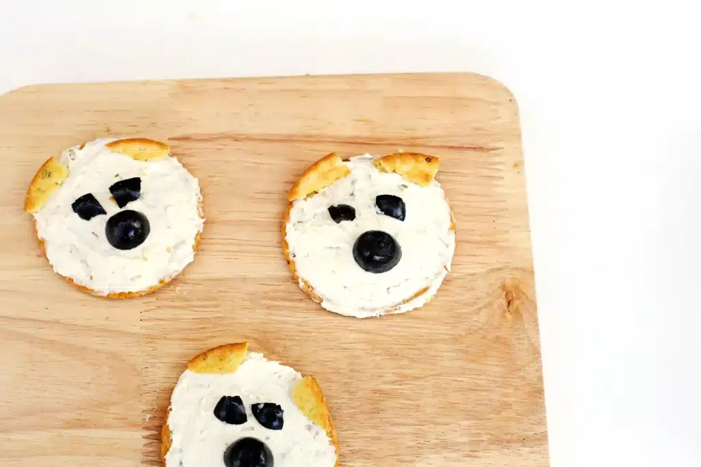 Savory Polar Bear Snacks - Cultivating Brilliant Minds crackers with cream cheese and olives to look like a polar bear