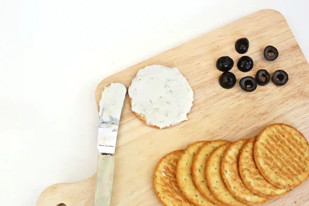 Savory Polar Bear Snacks - Cultivating Brilliant Minds cream cheese spread on a round cracker