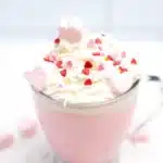 Strawberry White Hot Chocolate - Cultivating Brilliant Minds strawberry white hot chocolate with whipped cream and heart sprinkles