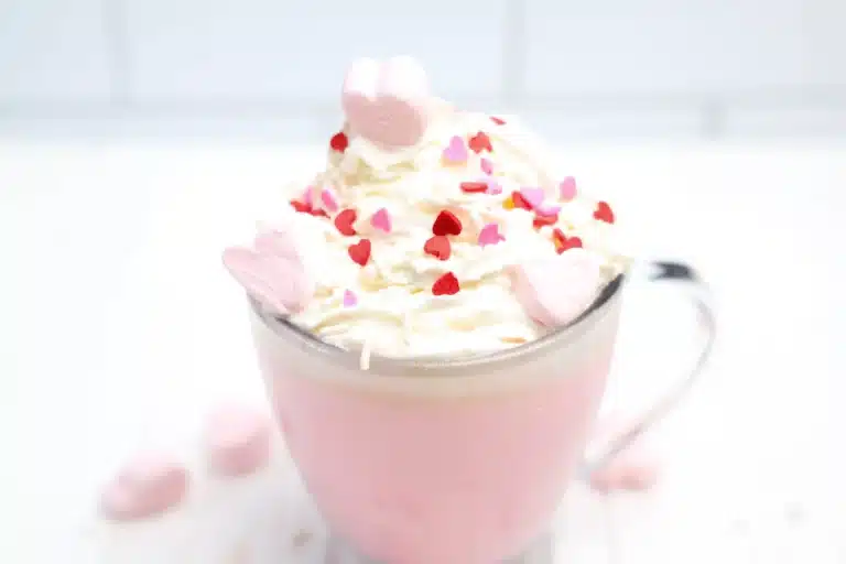 strawberry white hot chocolate with whipped cream and heart sprinkles