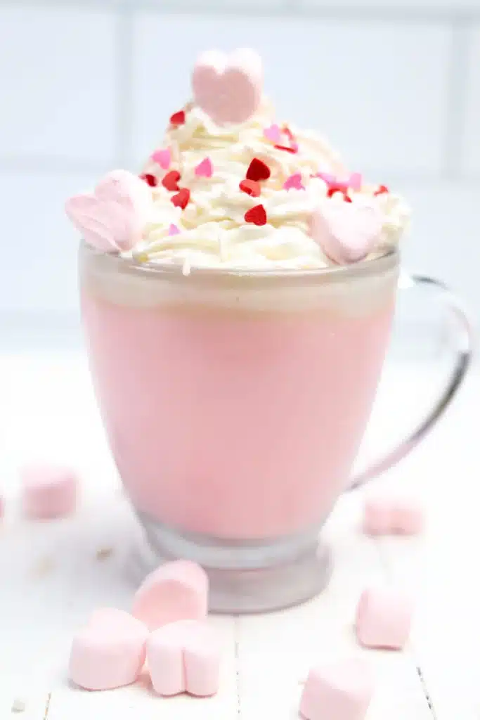 Strawberry White Hot Chocolate - Cultivating Brilliant Minds strawberry white hot chocolate with whipped cream and heart sprinkles