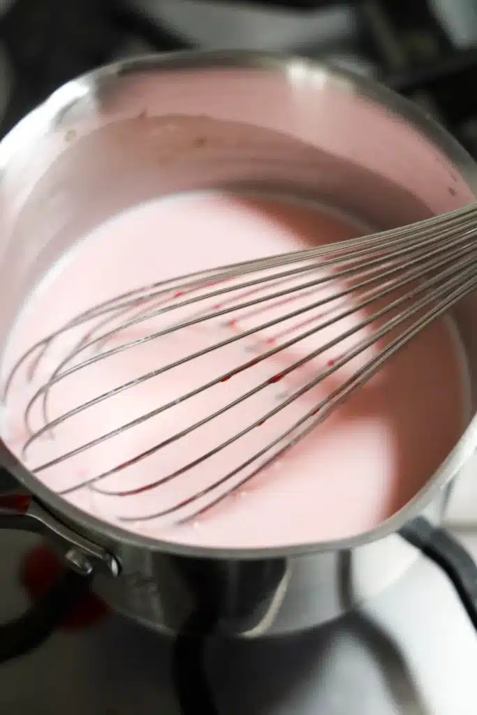 Strawberry White Hot Chocolate - Cultivating Brilliant Minds melted white chocolate, milk, strawberry marshmallows, and strawberry syrup in a pot