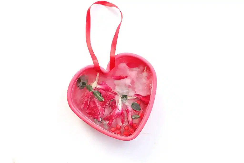 Ice Heart Suncatchers - Cultivating Brilliant Minds ice heart suncatcher made with leaves, petals, and betties