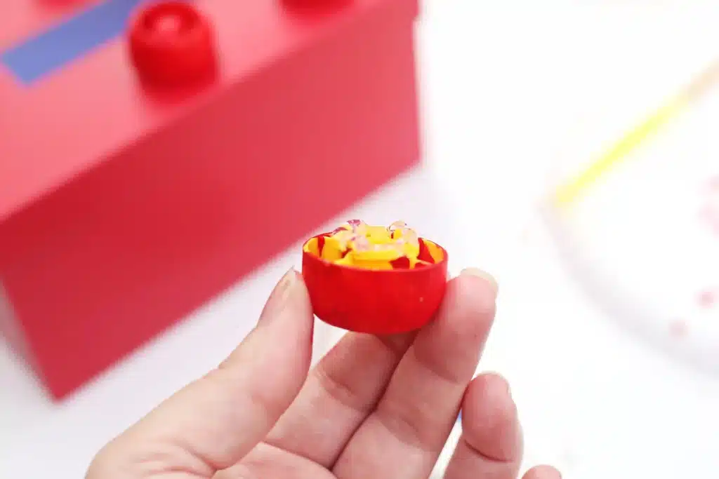 DIY LEGO Valentine Box - Cultivating Brilliant Minds glue on an apple sauce lid that is painted red