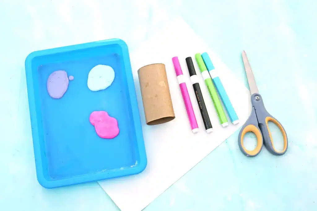 Bunny Stamp Art with Toilet Paper Rolls - Cultivating Brilliant Minds paint, a toilet paper roll, colored markers, scissors, and a piece of paper