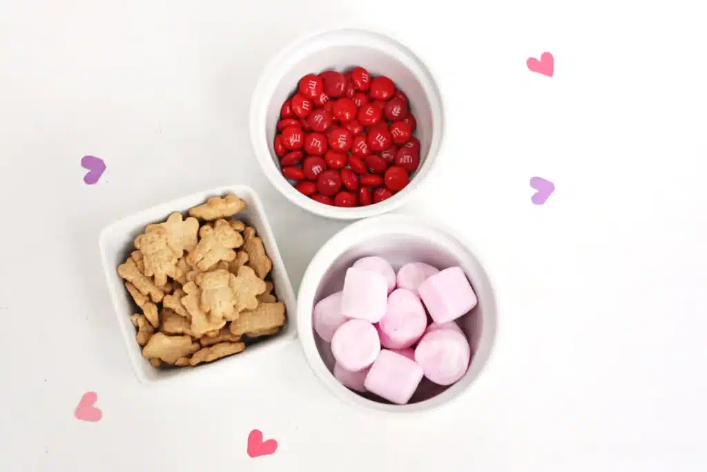Valentine's Day Cupid Snack Mix - Cultivating Brilliant Minds teddy grahams, pink marshmallows, and red m&ms