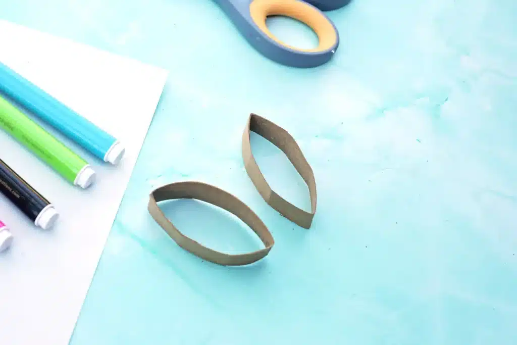 Bunny Stamp Art with Toilet Paper Rolls - Cultivating Brilliant Minds a toilet paper roll with two small strips cut off and shaped into bunny ears