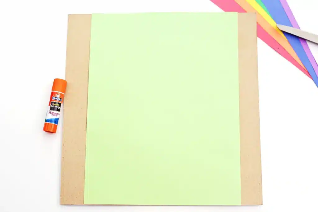 DIY Paper Leprechaun Trap STEM Craft - Cultivating Brilliant Minds a piece of green paper glued to a piece of cardboard