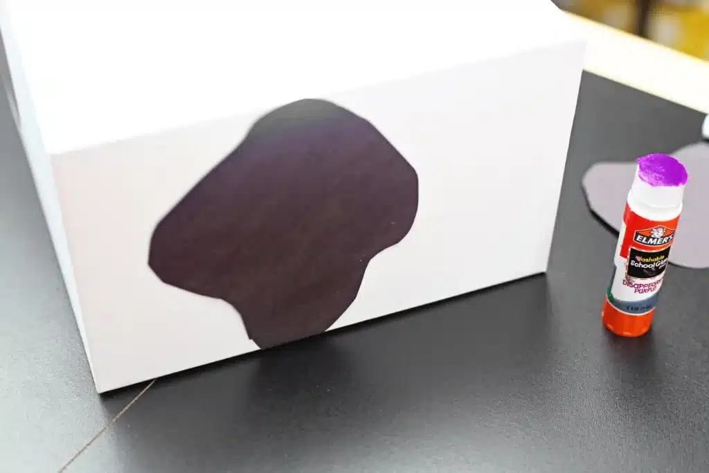 Cow Valentine Box - Cultivating Brilliant Minds black spots cut out of construction paper glued onto the white valentine box