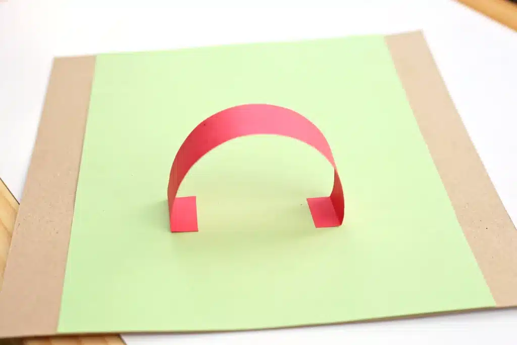 DIY Paper Leprechaun Trap STEM Craft - Cultivating Brilliant Minds a red strip of construction paper glued in an arch
