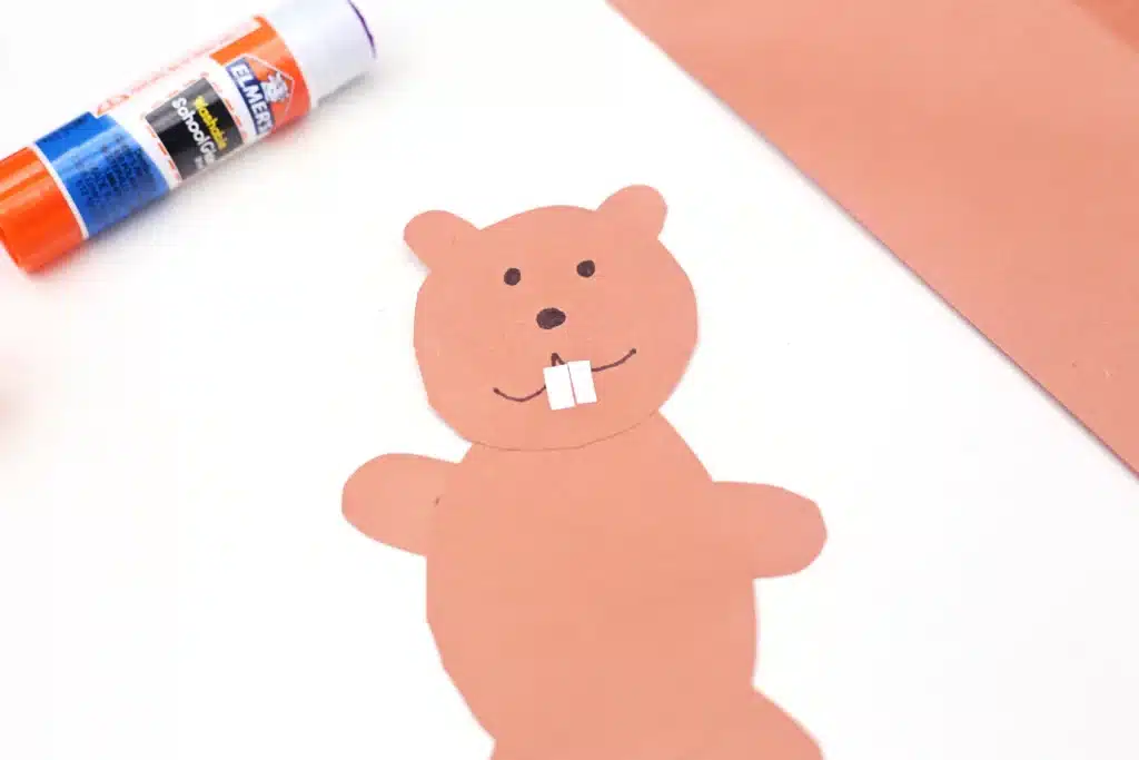 Groundhog Day Shadow Experiment - Cultivating Brilliant Minds a groundhog shape cut out of brown construction paper with a face drawn on with black marker