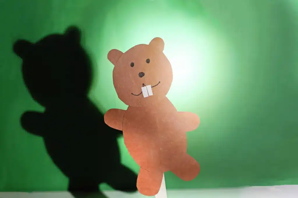 Groundhog Day Shadow Experiment - Cultivating Brilliant Minds a groundhog made out of construction paper glued to a popsicle stick with a light shining on it to see the shadow
