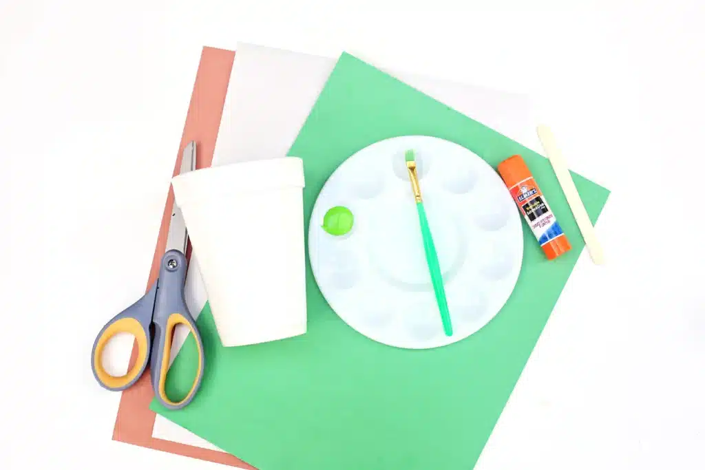Groundhog Day Craft For Kids - Cultivating Brilliant Minds colored construction paper, scissors, a cup, green paint, a paintbrush, glue, and a popsicle stick