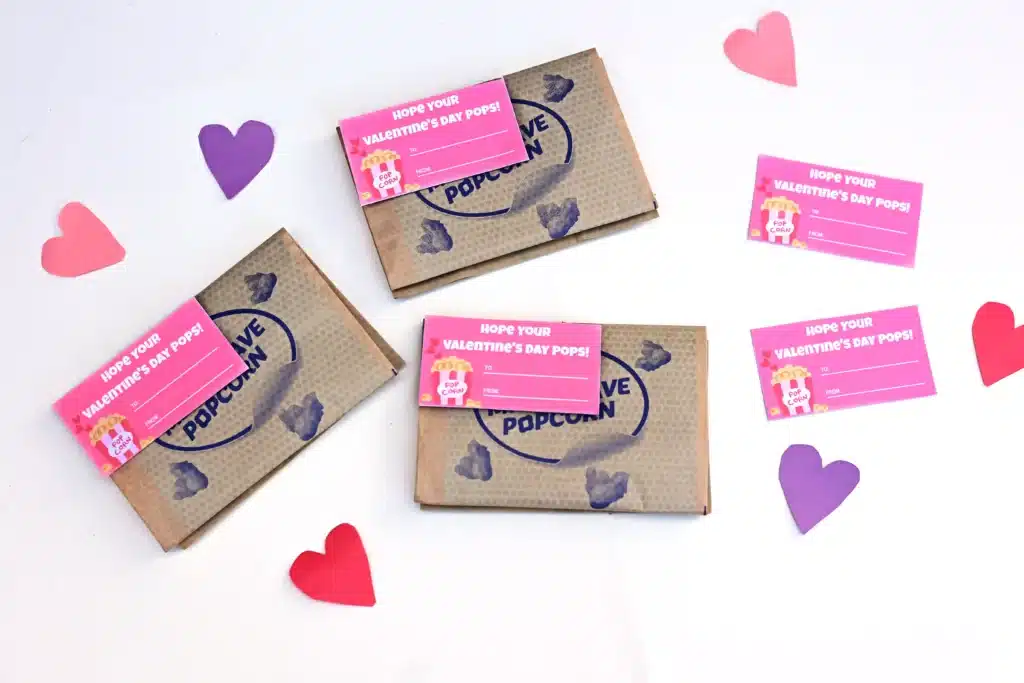 Printable Valentines - Cultivating Brilliant Minds printable valentine that reads "I hope you valentine's day pops!" attached to a bag of microwave popcorn.
