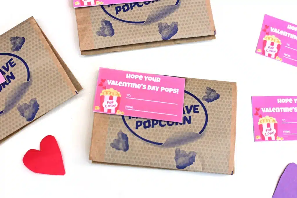 Printable Valentines - Cultivating Brilliant Minds printable valentine that reads "I hope you valentine's day pops!" attached to a bag of microwave popcorn.