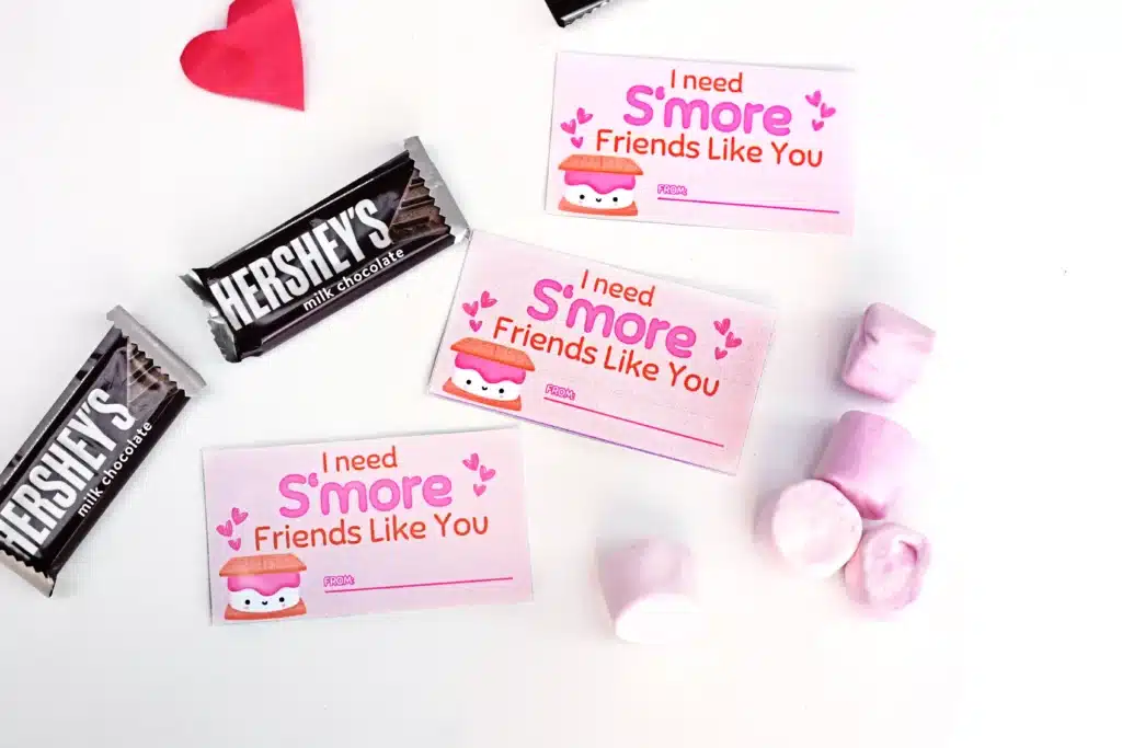 Printable Valentines I need s'more friends like you - Cultivating Brilliant Minds individual chocolate bars, pink marshmallows, and the printable valentine that reads "I need s'more friends like you"