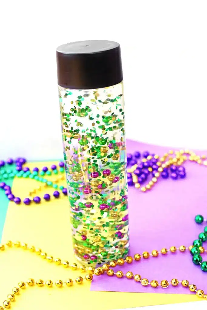 Mardi Gras Sensory Bottle - Cultivating Brilliant Minds a mardi gras sensory bottle that uses mardi gras beads and glitter in water